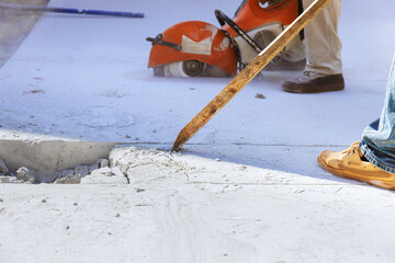 Wielding worker demolishes concrete old driveway at construction site
