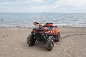 ATV Parked at seashore on clean  beach with beautiful skies