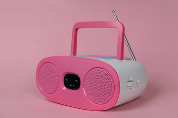 Pink stereo CD mp3 radio player on pink background. Cute children's radio and CD Player