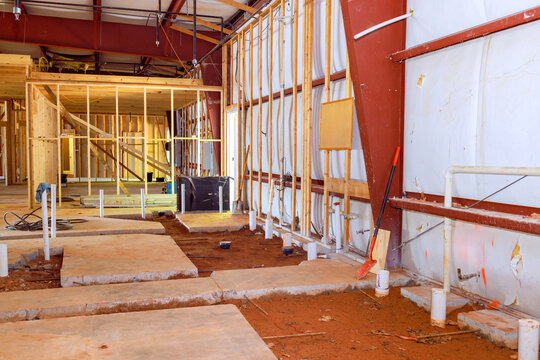 Lavatory restroom plumbing exposed drainage pvc pipe endings in concrete floor