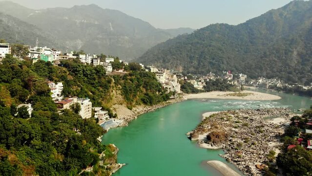 Aerial/Drone shot of Rishikesh City, Ram Jhula bridge situated on Holy River Ganga in Rishikesh, holy town and travel destination in India, Hindus capital 4k