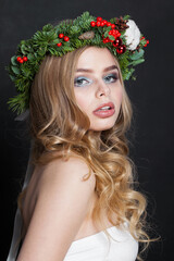 Naklejka premium Christmas beauty woman. Gorgeous model with makeup, clean fresh skin, wavy blonde hair, perfect smile and Xmas New Year decoration