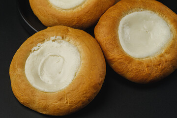 Sweet buns with cottage cheese on a black background