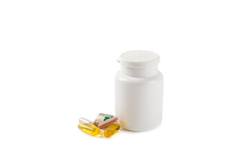 Vitamins and supplements. A variety of vitamin tablets in a jar isolated on a white background. Multivitamin complex for every day. Nutritional supplements. Place for text. Copy space.