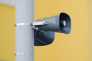 Town broadcast speaker siren in residential area in small city. Emergency sirens are tested every...