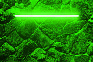 Green neon bulbs on stone wall. Background texture of empty old stone wall with glowing green neon lamps.