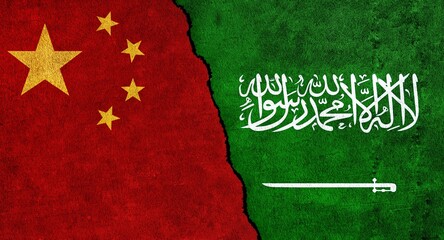 China and Saudi Arabia flag together on a textured wall. Relations between Saudi Arabia and China