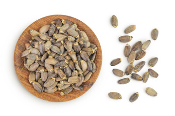 Seeds of a milk thistle or Silybum marianum, Scotch Thistle, Marian thistle in wooden bowl isolated on white background. Top view. Flat lay