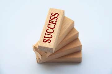 Success text on top of wooden blocks with white cover background. Success concept.