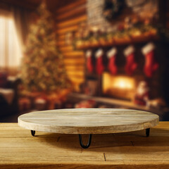 Wooden table with pedestal and christmas interior with fireplace. Cold december day and magic time. 