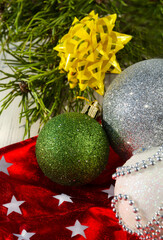Decorations for the New Year and Christmas. Green ball, bows and stars, on a red background.