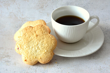 cup of coffee with biscuits isolated on gray background 