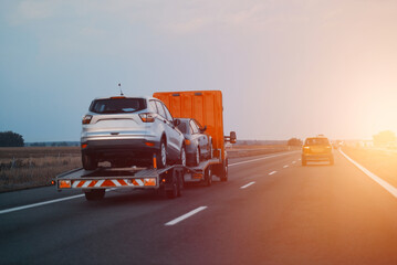 A Tow Truck With Brand New Cars For Sale. New Car Delivery And Shipping. Car Transporter Trailer...