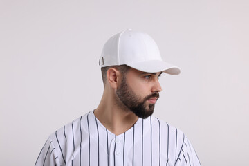 Man in stylish baseball cap on white background