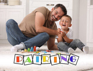 Pairing. Father and his son playing together on floor indoors