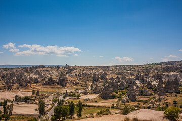 Fototapeta na wymiar Rocky landscape in Cappadocia, Turkey. Travel in Cappadocia. Unusual semi-desert mountain ranges. Amazing Rocky summer landscape in Cappadocia Goreme