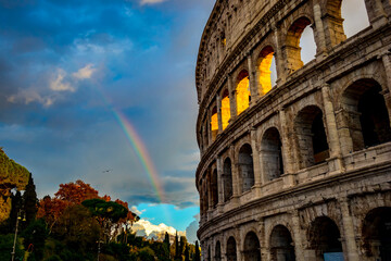 The colosseum with rainbow by its left side, Rome, the capital city of Italy, elevated street travel view