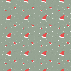 Seamless pattern of Santa’s hats on green background