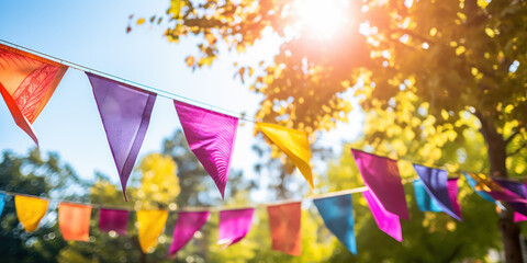 Colorful flags crisscross in the breeze, adding whimsy to a bright, leafy backdrop.