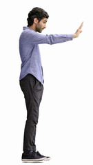 young man in full growth. isolated on white background shows stop sign with hand