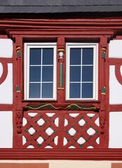 Architectural detail of a half-timbered facade with windows on a residential house in the old medieval village of Monzingen, Germany