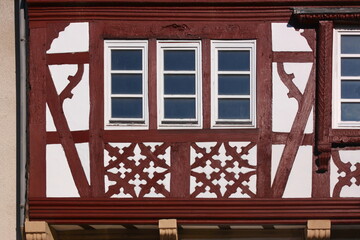Architectural detail of a half-timbered facade with windows on a residential house in the old...