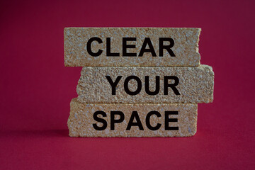 Clear your space symbol. Brick blocks with words Clear your space. Beautiful red background. Business, clear your space concept, copy space.