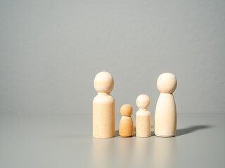 Wooden figures. Family on a gray background. Family values concept.