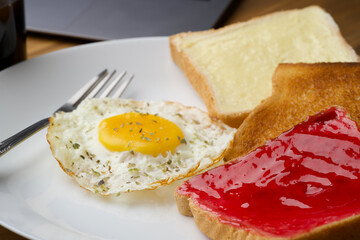 Break fast items like bread butter, bread jam, omelet and black filter coffee