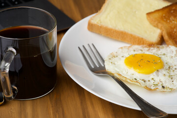 Breakfast items like sunny side up omelet jam bread butter bread and black filter coffee