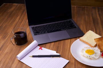 Fried Egg with butter bread Toast and cup of Coffee for Breakfast. sunny side up egg with jam bread on plate over wooden table.