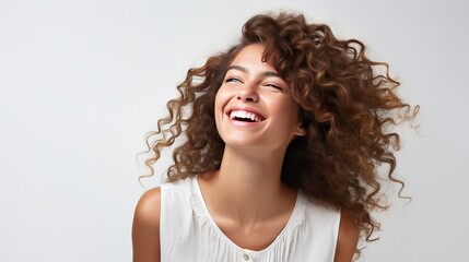A woman who is caucasian and happy is posing and laughing, but she is isolated on white