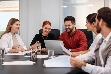 Team of employees working together in office