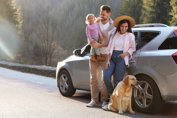 Parents, their daughter and dog near car outdoors, space for text. Family traveling with pet