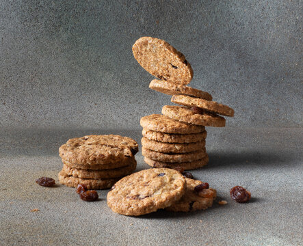 Stack of oatmeal cookies with raisin on a grey background