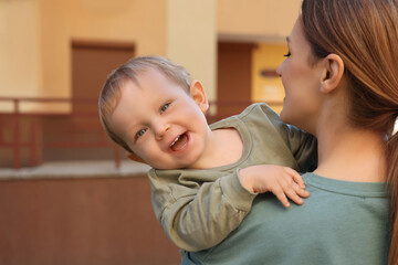 Portrait of nanny with cute little boy outdoors