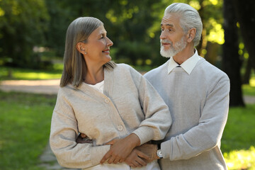 Fototapeta premium Affectionate senior couple spending time together in park. Romantic date