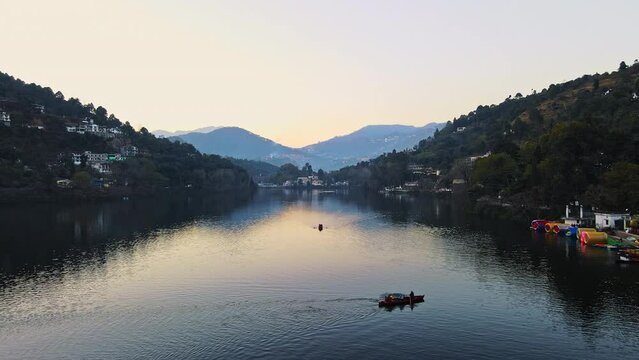 Aerial view of Bhimtal lake in Nainital, Uttarakhand. Drone view of a beautiful lake situated amidst hills of Himalayas. Sunset view of a Bhimtal lake in Kumaon, India. Lake views in the mountains. 