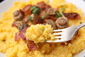 Fork with tasty fresh cornmeal, closeup view