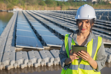 Asian engineer working at Floating solar farm,Renewable energy,Technician and investor solar panels checking the panels at solar energy installation