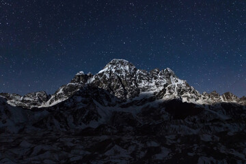 Mountain under starry sky in Himalayas, Nepal. Mountain Himalayan landscape at Night. Everest...