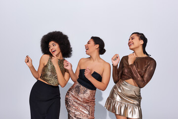 joyous african american women in festive attires with sequins partying together, fashion concept