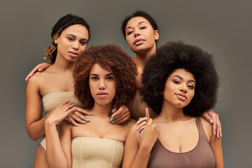 attractive young african american women in pastel underwear looking at camera, fashion concept