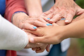 Concept of family, aging society or teamwork, hands showing unity with putting hands together,...
