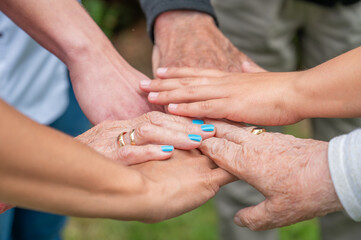 Concept of family, aging society or teamwork, hands showing unity with putting hands together,...