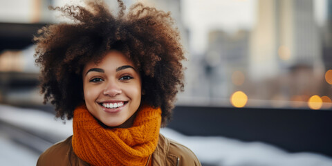 Radiant young African American woman with afro hair smiling brightly, dressed in winter fashion, on...