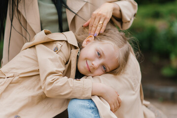 Happy girl daughter is lying on her mother's lap. Care and Mother's Day