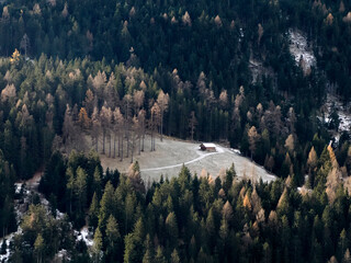 Isolated wooden hut in the glade of radura Dolomites park of Lavaredo Peaks of Mountain Torre dei...