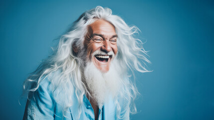 Positive and joyful older man male with long beard and hair bursting into laughing.