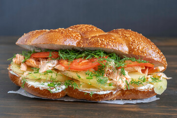 Challah Sandwich made with salmon, potato, tomatoes, cream cheese, fennel.